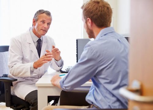 Doctor speaking with a patient in his office
