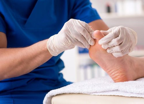 Podiatrist touching a patient's foot