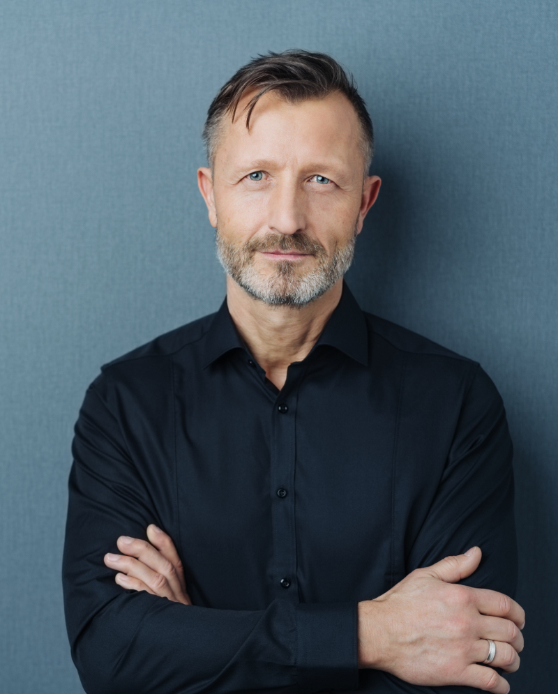 Smiling older man wearing a dark shirt