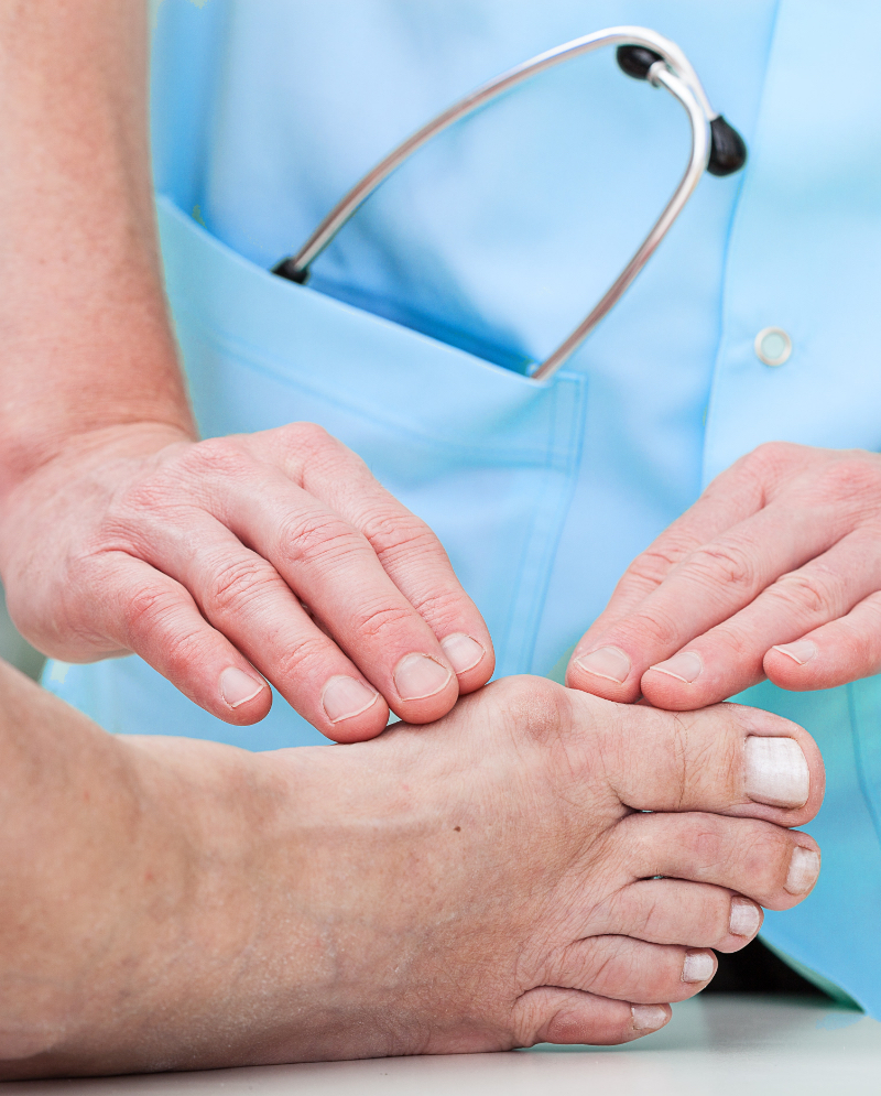 A doctor checking a male patient's feet