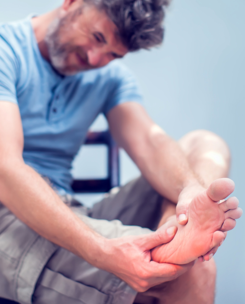 Man grabbing his foot in pain