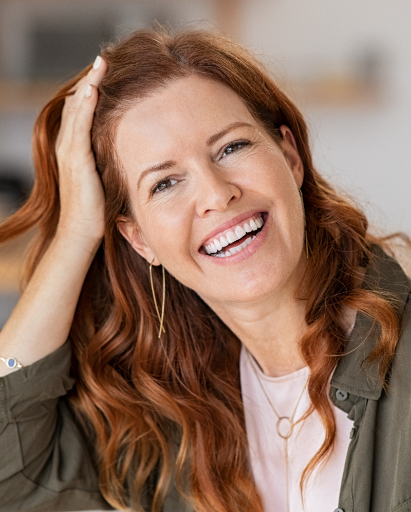 Smiling, older woman with red hair