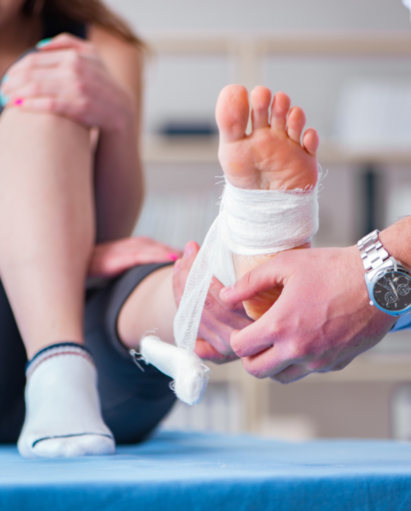 Doctor wrapping a patient's foot in a bandage