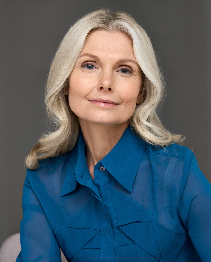 Happy older woman wearing a blue blouse